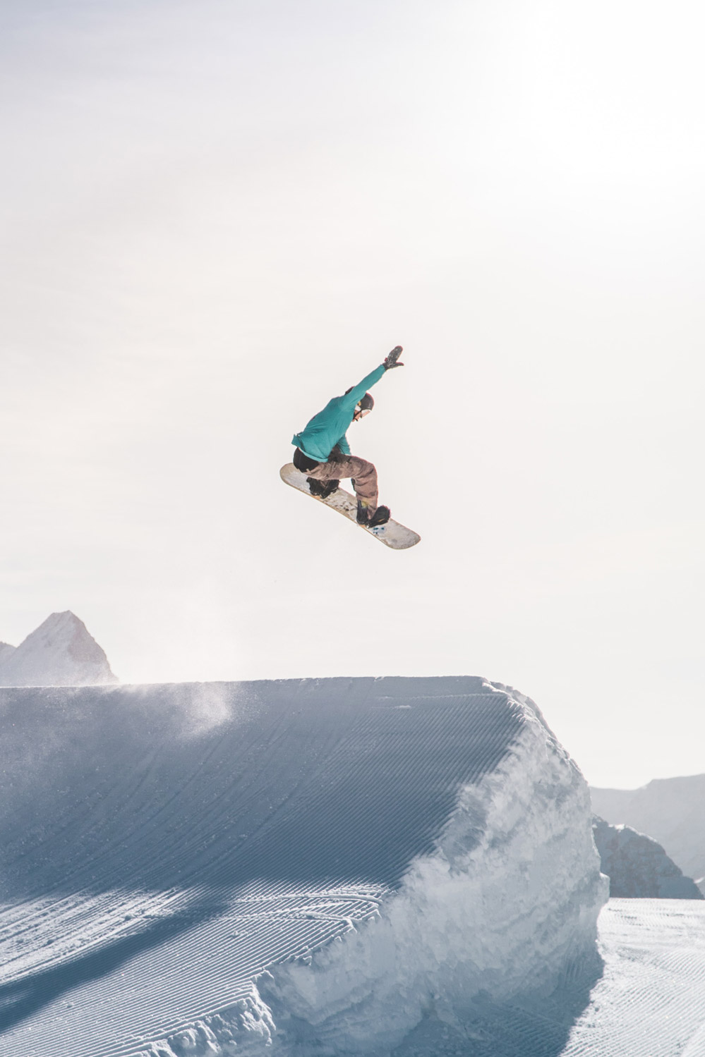Photo of a snowboarder jumping off a ski jump